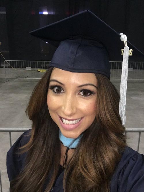 Vanessa Macia taking a photo after graduation.